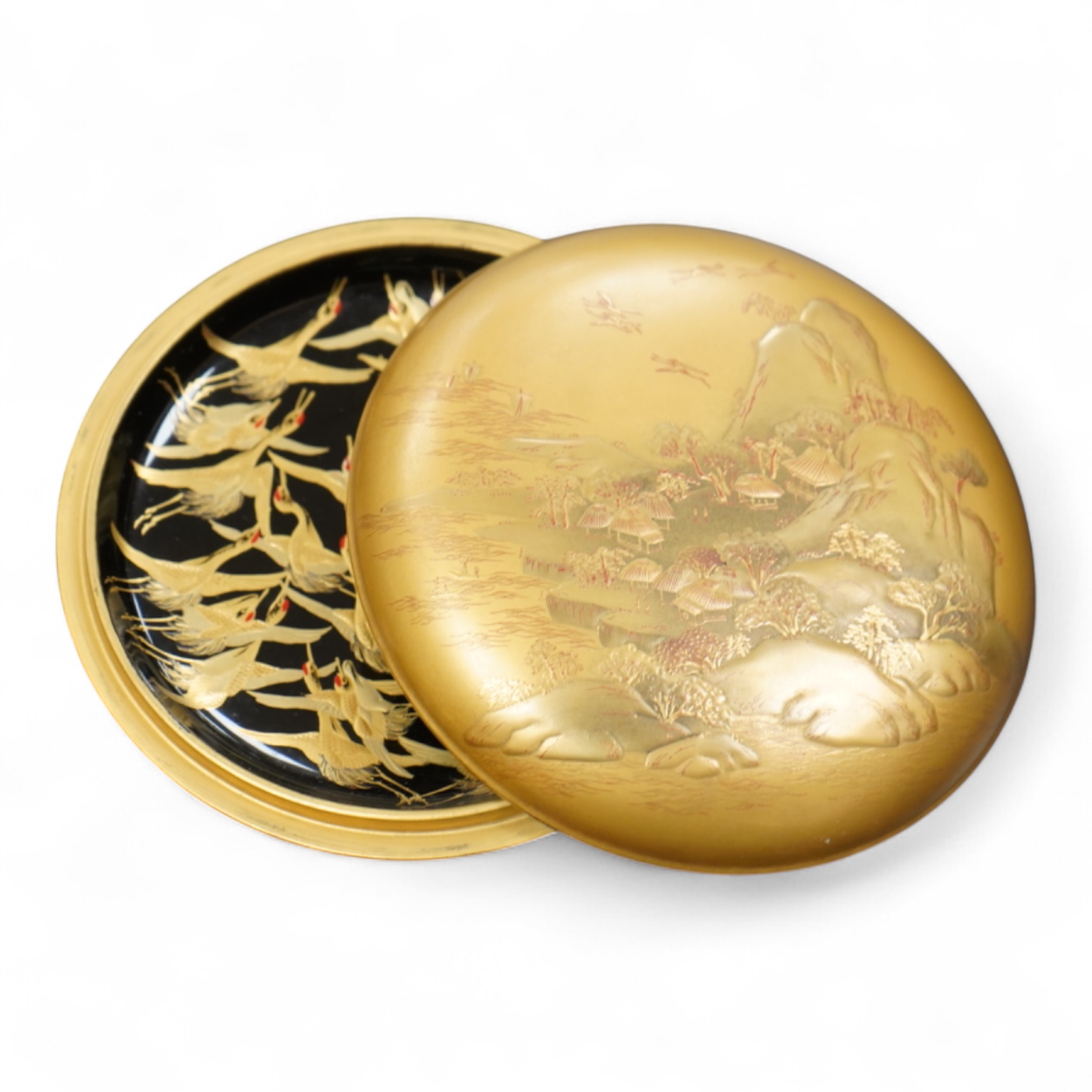A Japanese circular gilt lacquer box decorated in relief, with paperwork, 10cm in diameter